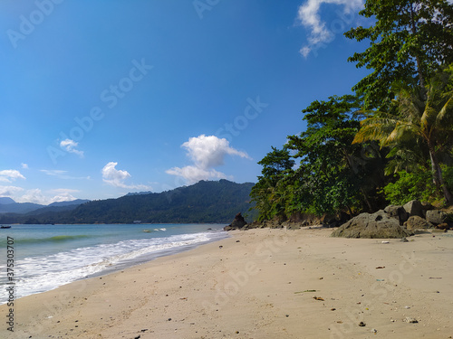 Fototapeta Naklejka Na Ścianę i Meble -  Tropical beach with blue sky and clean sand in Indonesia