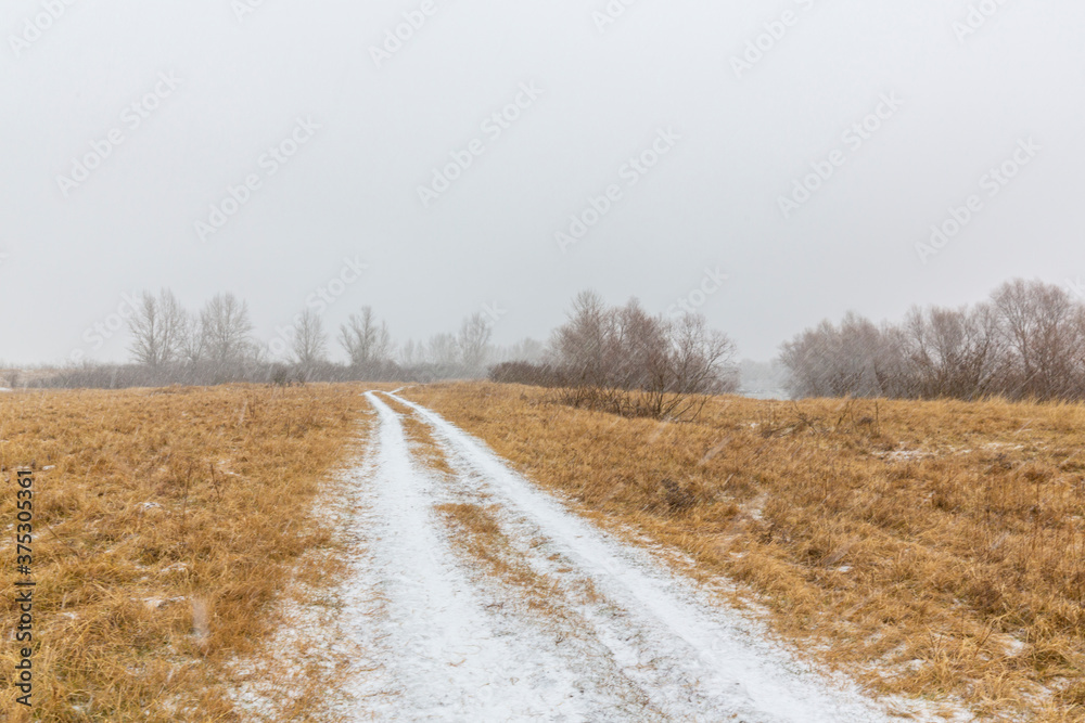 Fresh powder snow covering a windy country road, in winter Fresh powder snow covering a windy country road, in winter