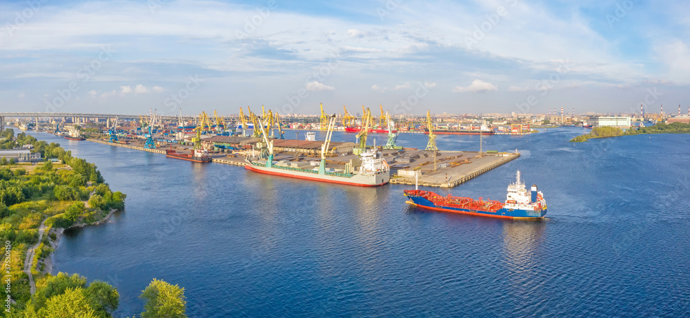 Panoramic aerial view of the industrial city port by the sea.