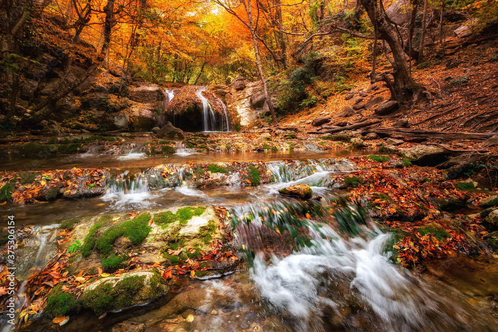 Scenic view autumn landscape with beautiful waterfall at mountain river in the forest with. Stones with moss in the water. Blurred water. Scenic view autumn landscape with beautiful waterfall at mountain river in the forest with. Stones with moss in the water. Blurred water.