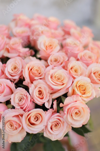 Beautiful flower bouquet of peach rose. Big bouquet of roses in vase on table.