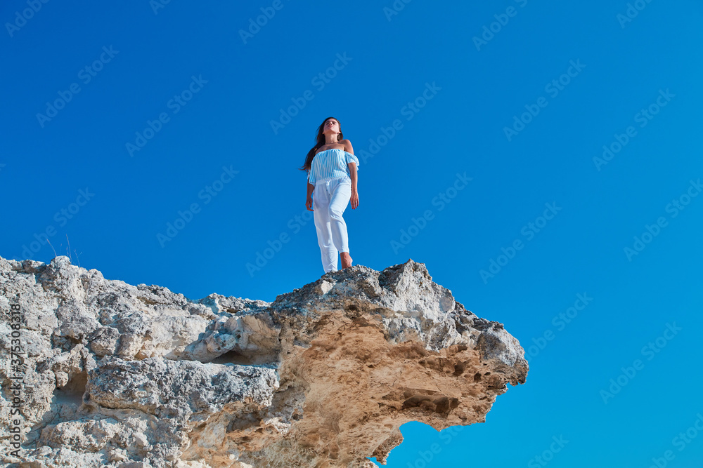 Lady looking up standing on high mountain. Relaxation or Modeling on Virgin nature. Woman posing on fresh air Lady looking up standing on high mountain. Relaxation or Modeling on Virgin nature. Woman posing on fresh air
