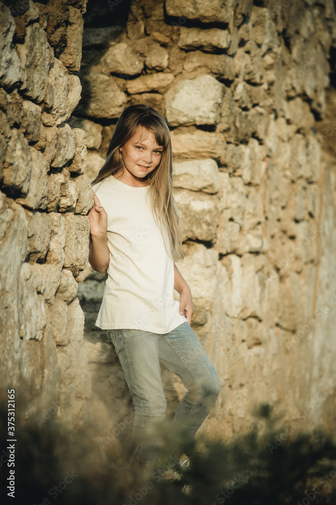 teenage girl resting by an abandoned building