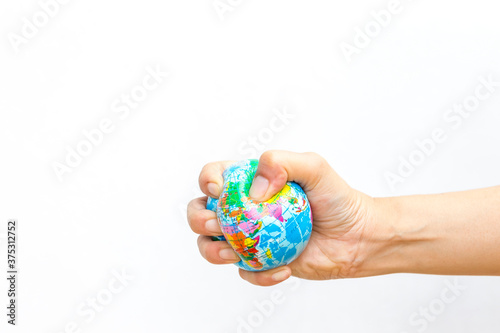 Global stress ball in girl hand on white background, squeeze the world