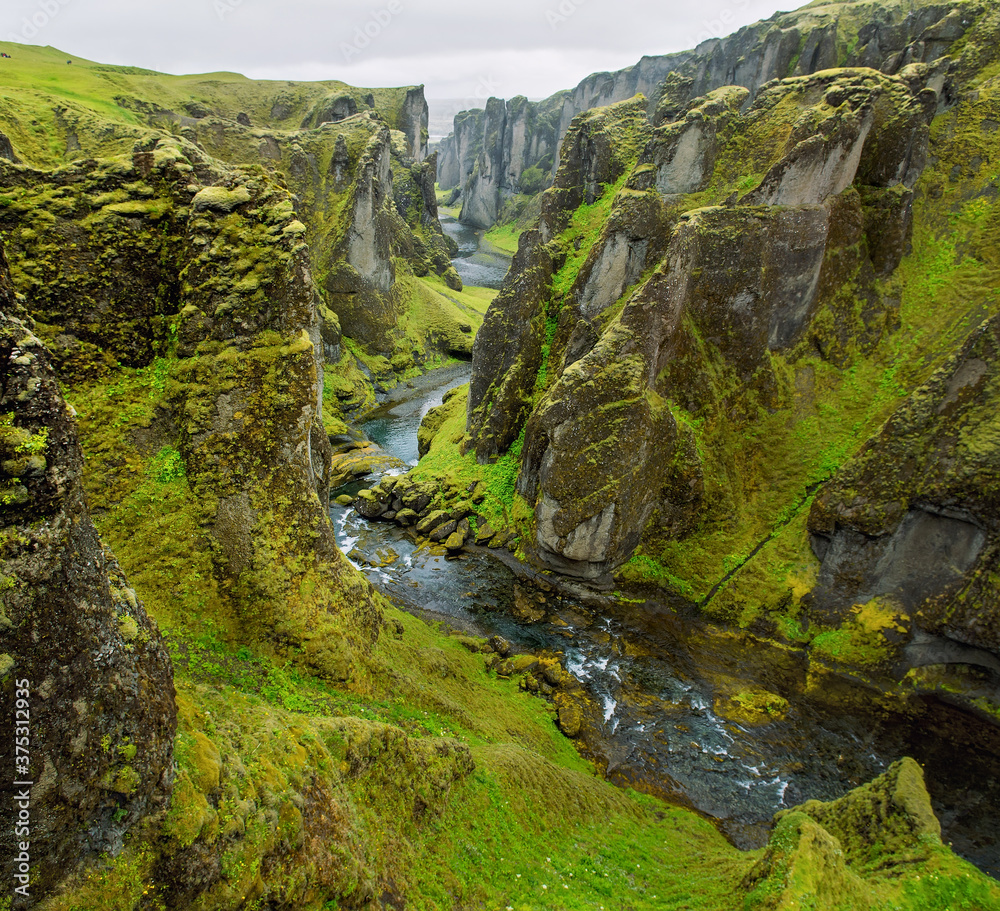 Canyon leading to the Icelandic waterfalls. Canyon with river and high cliffs