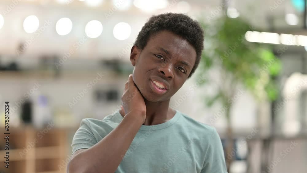 Young African Man with Laptop having Neck Pain Young African Man with Laptop having Neck Pain
