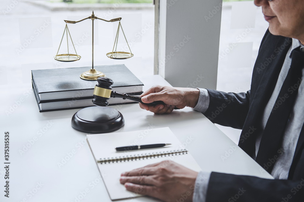 Judge gavel with Justice lawyers, Counselor in suit or lawyer working with contract papers on a documents in courtroom, Legal law, advice and justice concept Judge gavel with Justice lawyers, Counselor in suit or lawyer working with contract papers on a documents in courtroom, Legal law, advice and justice concept
