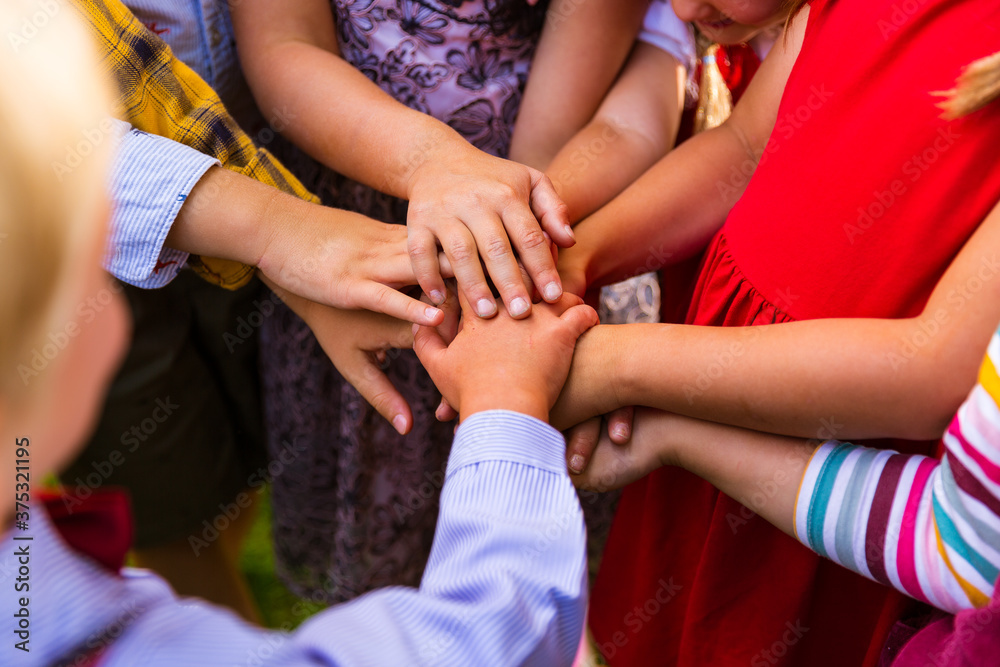 Obraz premium Kids joining hands together
