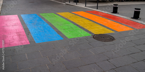 Fototapeta Naklejka Na Ścianę i Meble -  street pedestrian crossing in colors rainbow flag sign to sex discrimination concept of the LGBT community in city center