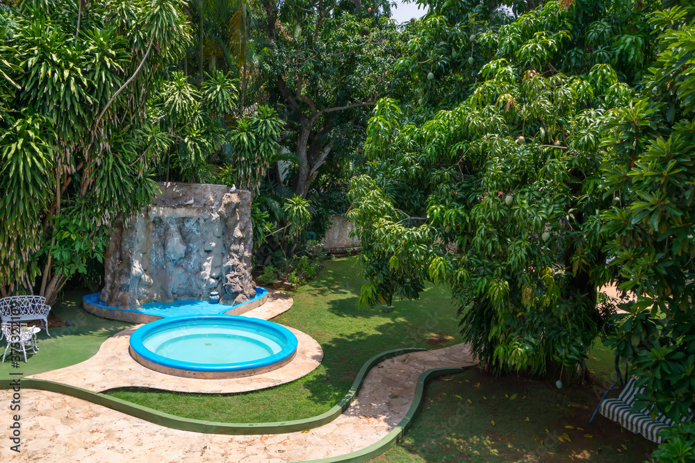 Resting place in a tropical garden with a swimming pool