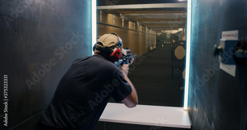 Professional shooter firing at target