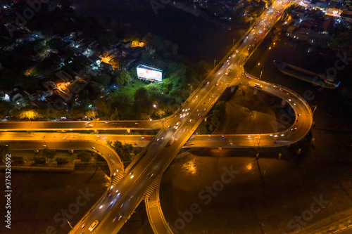 symmetrical Aerial view of freeway interchange offramp and bridge over canal with traffic photo