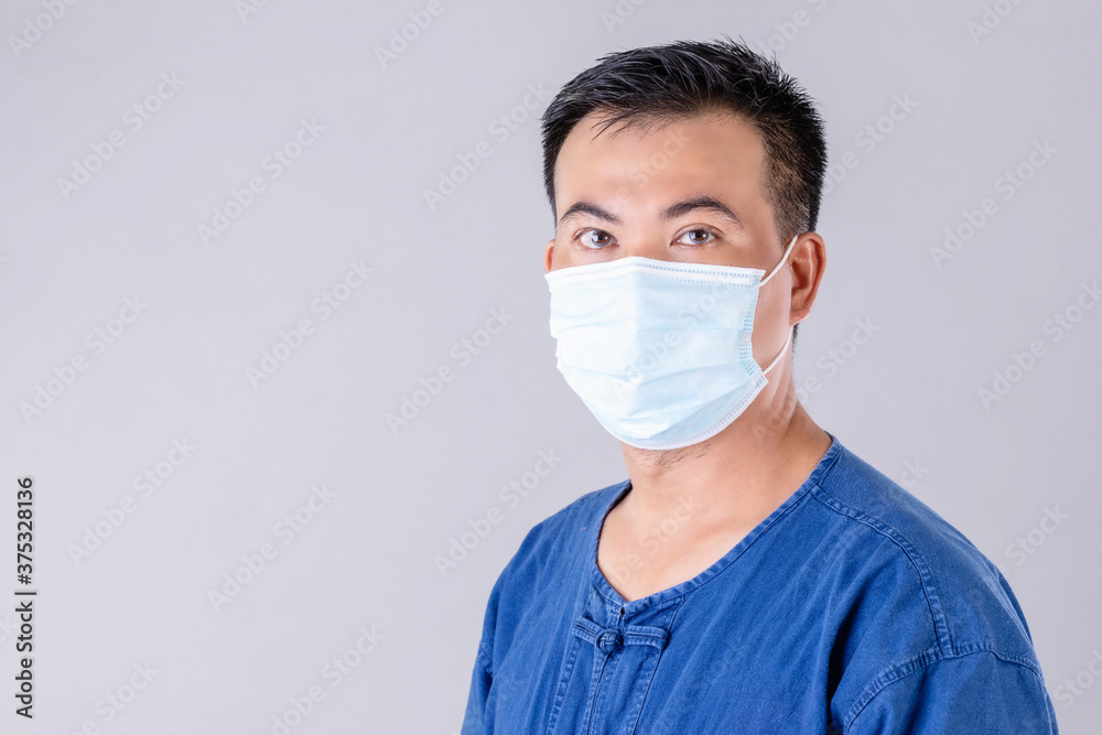 Thai farmer wearing protective face mask to prevent virus studio shot on grey background Thai farmer wearing protective face mask to prevent virus studio shot on grey background