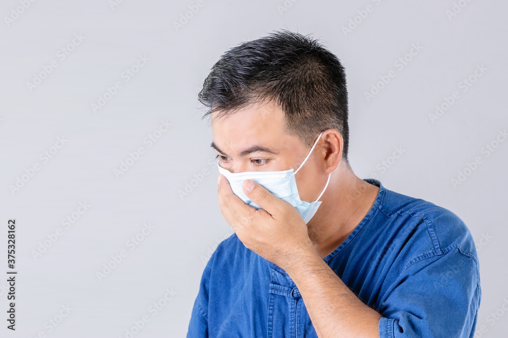 Thai farmer wearing protective face mask to prevent virus studio shot on grey background Thai farmer wearing protective face mask to prevent virus studio shot on grey background