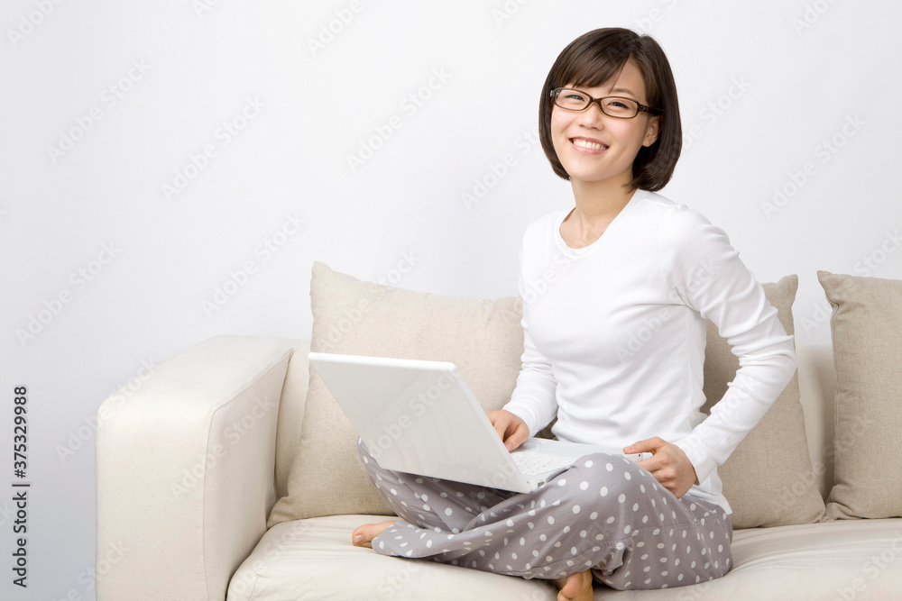 young woman using a laptop on sofa