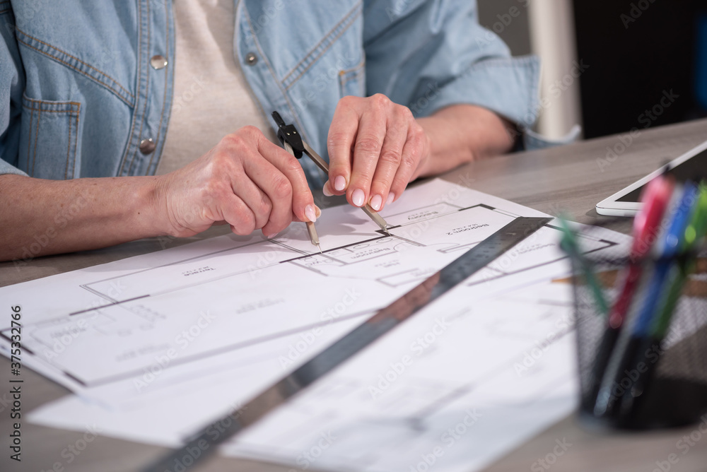 Female architect working on blueprint