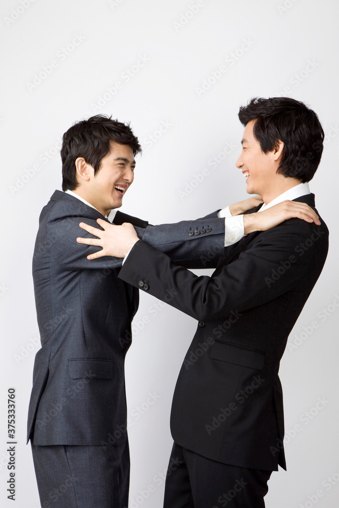 young businessmen hugging each other young businessmen hugging each other