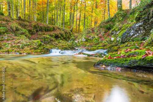 Fototapeta Naklejka Na Ścianę i Meble -  Autumn. Explosion of colors on the waterfalls and streams of the Val d'Arzino.