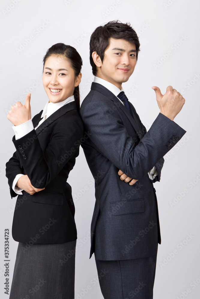 young businessman and businesswoman looking at camera back to back young businessman and businesswoman looking at camera back to back