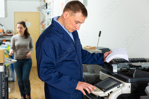Service engineer of the printing house during work. High quality photo