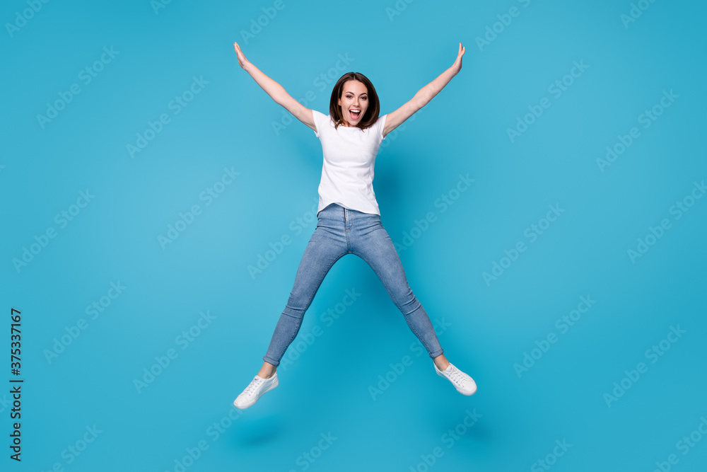 Full length body size view of her she nice attractive funky careless slim fit thin skinny cheerful cheery girl jumping having fun holiday isolated bright vivid shine vibrant blue color background