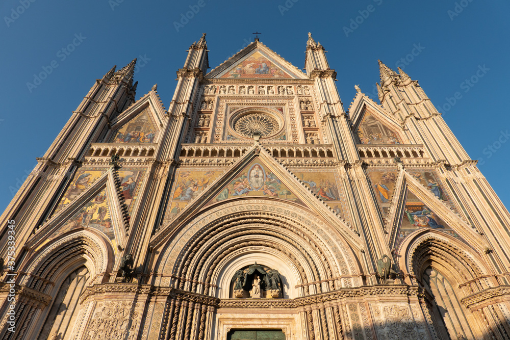 The facade of the cathedral of Orvieto, Italy, with its mosaics at sunset