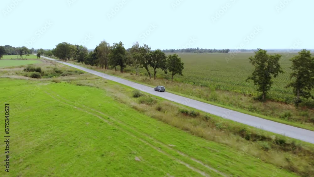 Aerial View Car Driving Road Agriculture Field in Summer Day. Road on Countryside Asphalt, Autumn Fields. Aerial View Road Trip Travel Journey Vacation Nature Countryside Rural Landscape. Aerial View Car Driving Road Agriculture Field in Summer Day. Road on Countryside Asphalt, Autumn Fields. Aerial View Road Trip Travel Journey Vacation Nature Countryside Rural Landscape.