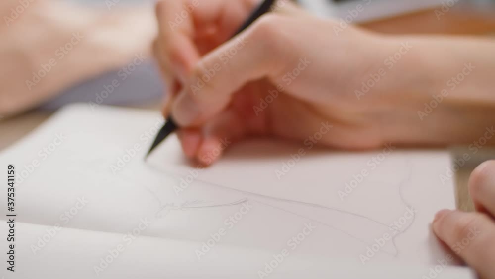 Young beautiful girl draw dress at home in living room Young beautiful girl draw dress at home in living room