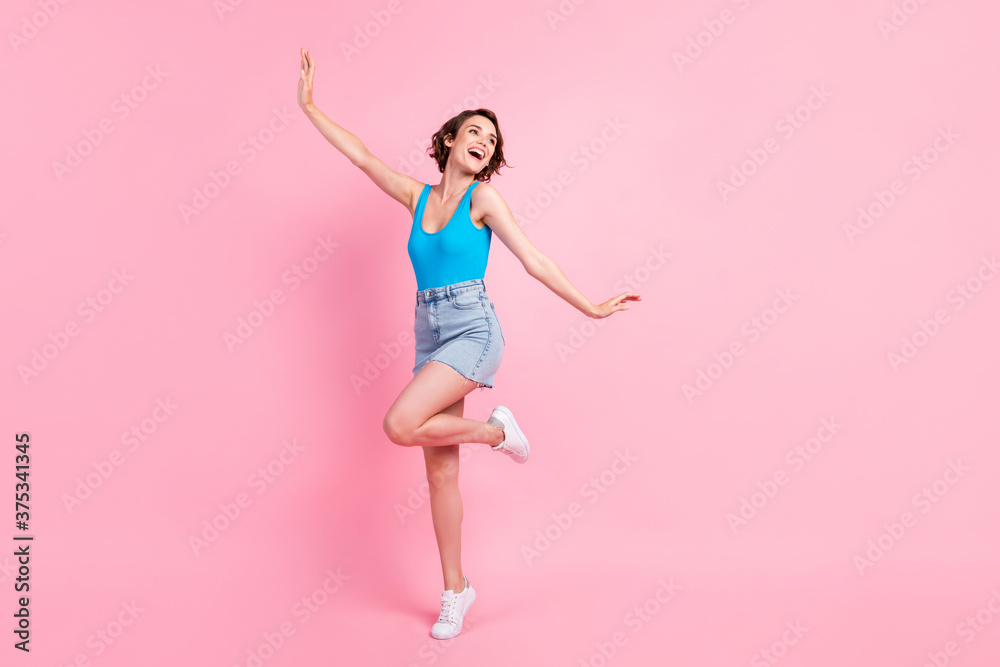 Full body size photo of cute charming student girl stay tip chilling smiling dreamy look open mouth weekend wear denim mini skirt blue singlet white sneakers isolated pink color background