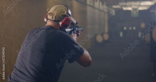 Unrecognizable man practicing in shooting range