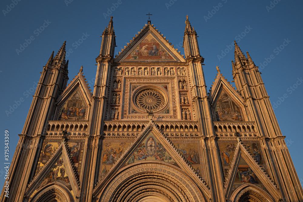 The facade of the cathedral of Orvieto, Italy, with its mosaics at sunset