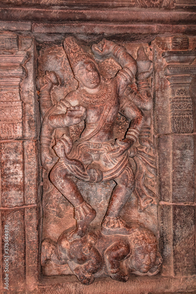 sculptures of hindu gods on facade of 7th century temple carved walls in Pattadakal