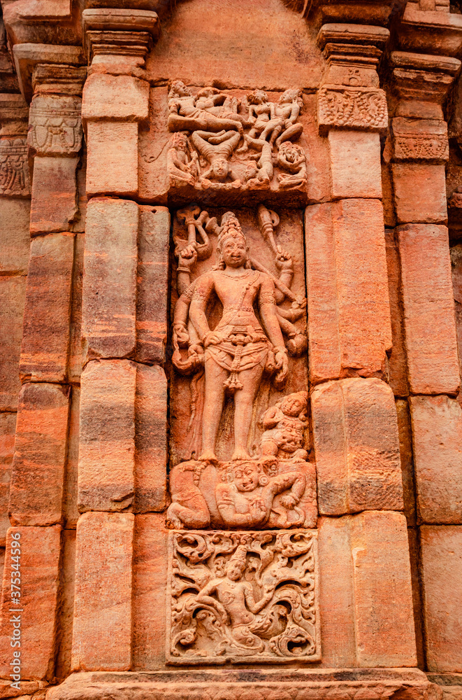 sculptures of hindu gods on facade of 7th century temple carved walls in Pattadakal