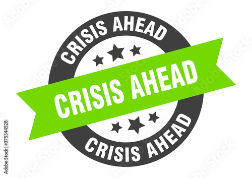 crisis ahead sign. round ribbon sticker. isolated tag
