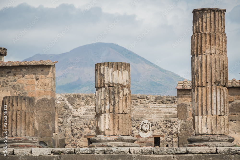 Fototapeta premium The Temple of Jupiter, Capitolium, or Temple of the Capitoline Triad, was a temple in the forum of Roman Pompeii with volcano Mount Vesuvius