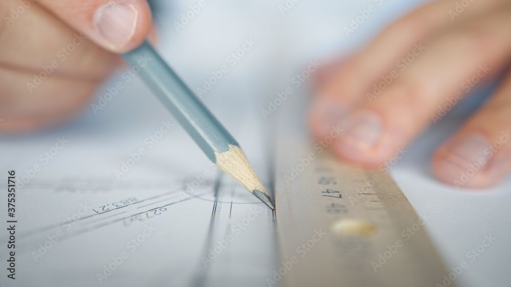 Architect's hands drawing a plan Architect's hands drawing a plan