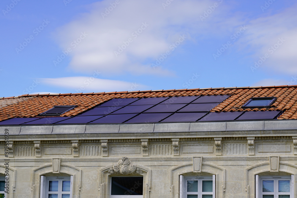 photovoltaic electrical solar panel on roof top of ancient house