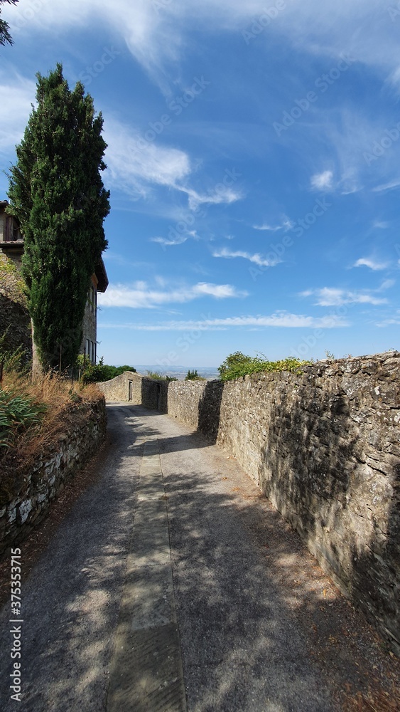 Street on the top of Cortona with the defensive walls on the right.