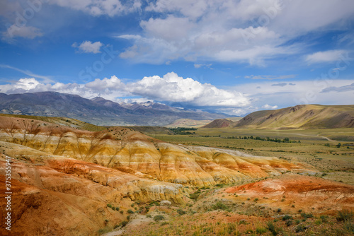 Amazing natural phenomenon-Martian landscapes in the Altai mountains. Multicolored rocks against a blue sky with white clouds. Futuristic panoramic picture, background image. Mars.
