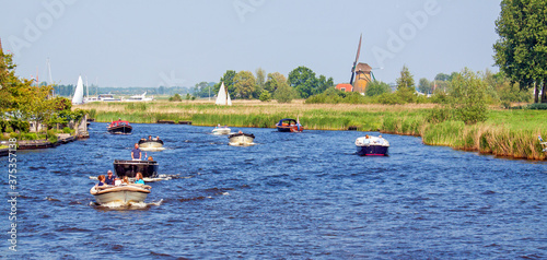 Konstfotografi Busy Leede river near Warmond, Netherlands, with recreational boats on a sunny s