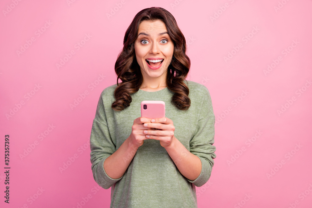 Portrait of astonished positive crazy girl use cellphone impressed by social network novelty followers subscribers wear good look sweater isolated over pastel color background Portrait of astonished positive crazy girl use cellphone impressed by social network novelty followers subscribers wear good look sweater isolated over pastel color background
