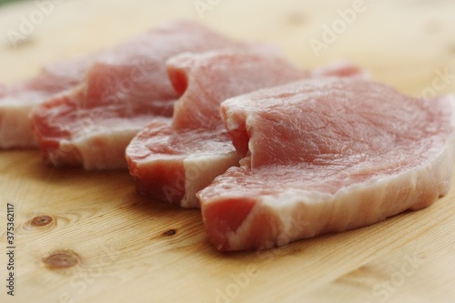 Fresh pork escalope on a wooden table