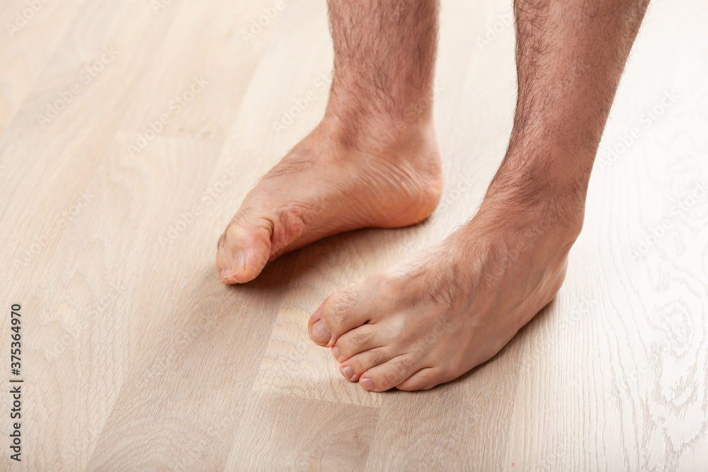 man doing flatfoot correction gymnastic exercise at home man doing flatfoot correction gymnastic exercise at home