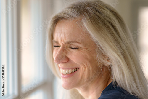 Laughing middle-aged blond woman