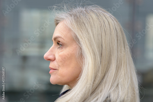Profile portrait of a blond middle-aged woman