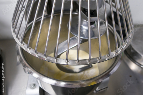 Close up for bread making process by using flour mixing machine.