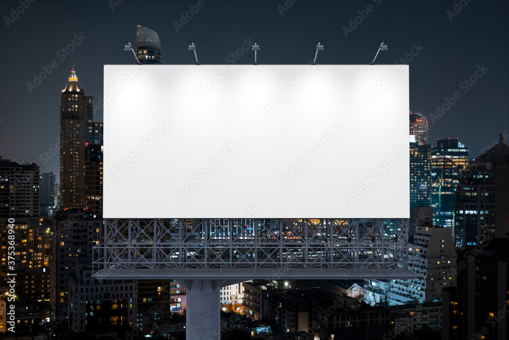 Obraz premium Blank white road billboard with Bangkok cityscape background at night time. Street advertising poster, mock up, 3D rendering. Front view. The concept of marketing communication to promote idea.