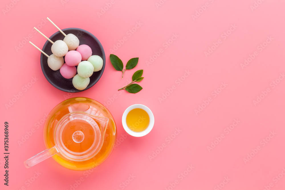 Japanese tea and sweet dumplings Dango on plate, top view