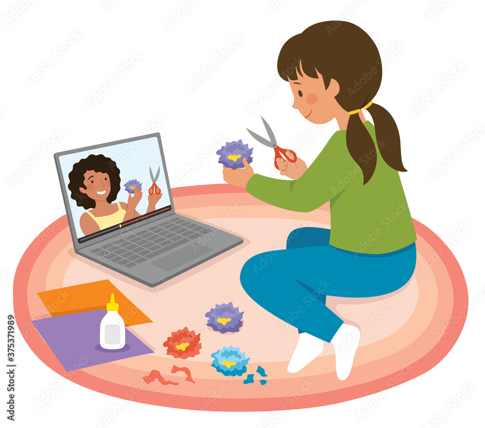 Little girl watching craft tutorial video on a laptop and making paper flowers Little girl watching craft tutorial video on a laptop and making paper flowers