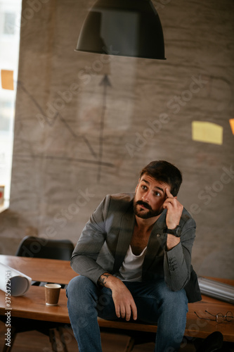 Businessman working on project. Tired businessman working in the office.